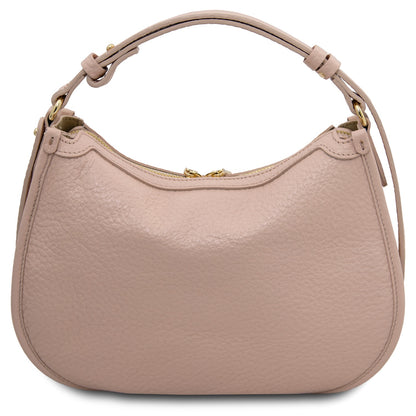 Pink leather hobo bag with a strap on a white background