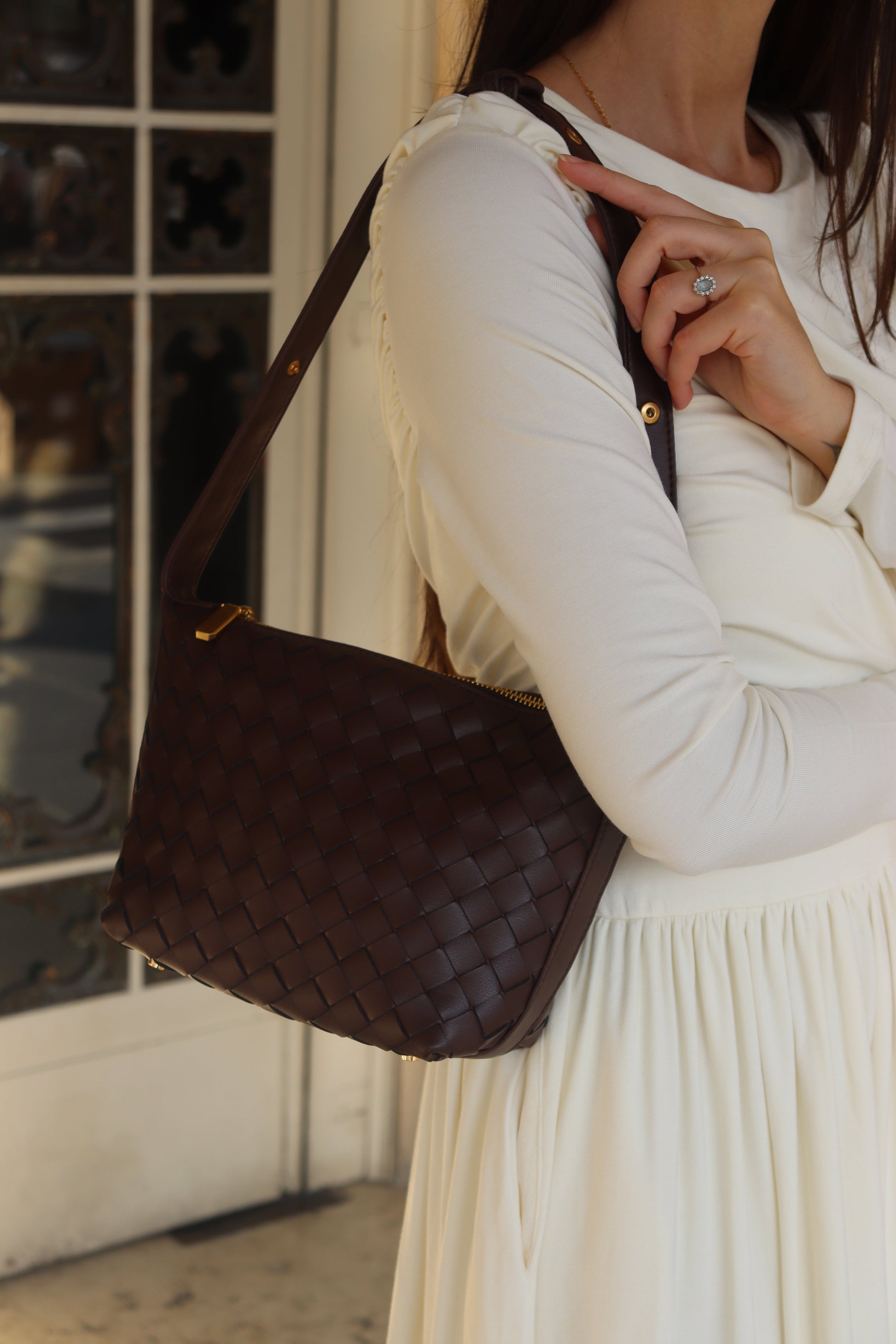 Braun genuine leather woven boxed pouch bag with a shoulder strap.
