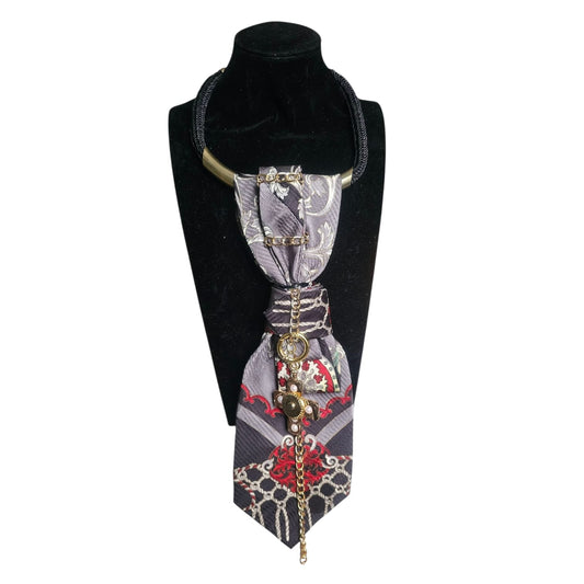 Imperial Cross 4-in-1 Jeweled Tie displayed on a bust with a gray floral tie and decorative cross pendant.
