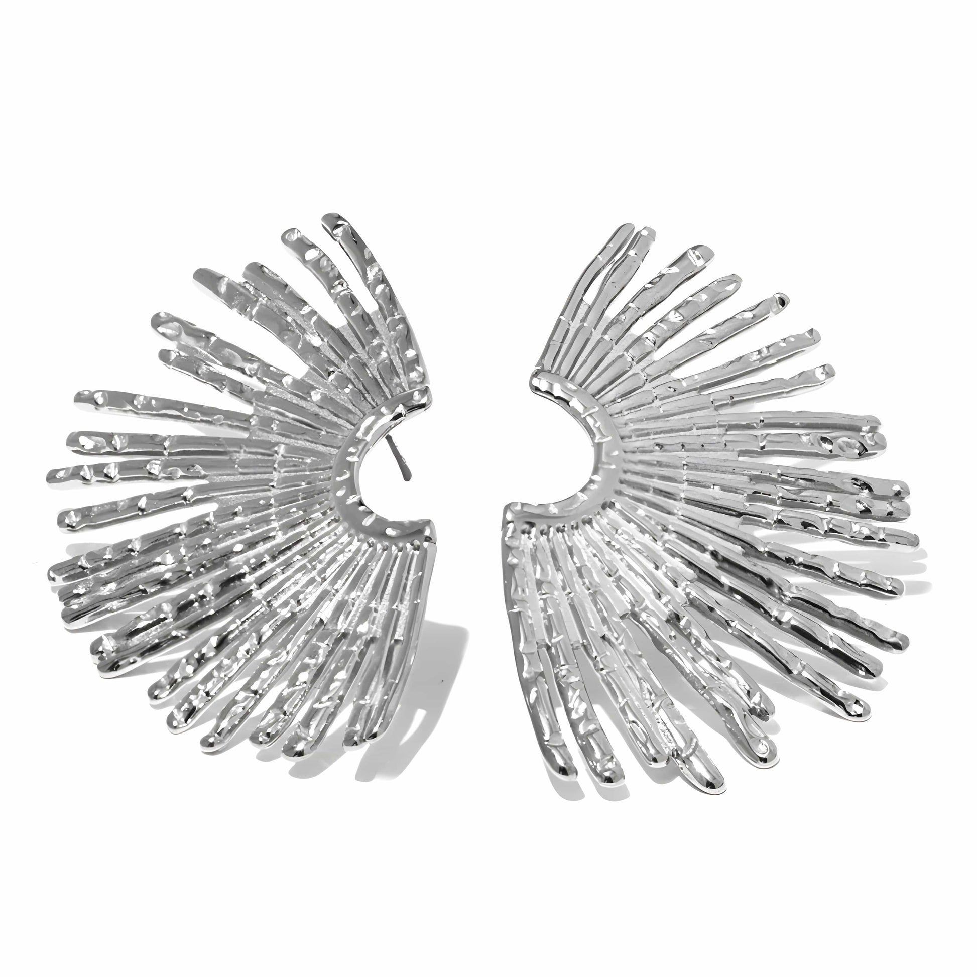 Silver wing-shaped earrings on a white background