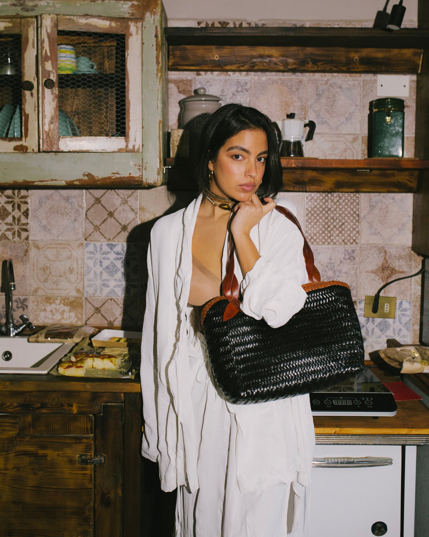 Léafa - Handwoven Leather Shoulder Bag | Brown & Black featuring woven black leather body and brown leather straps held by woman in white outfit