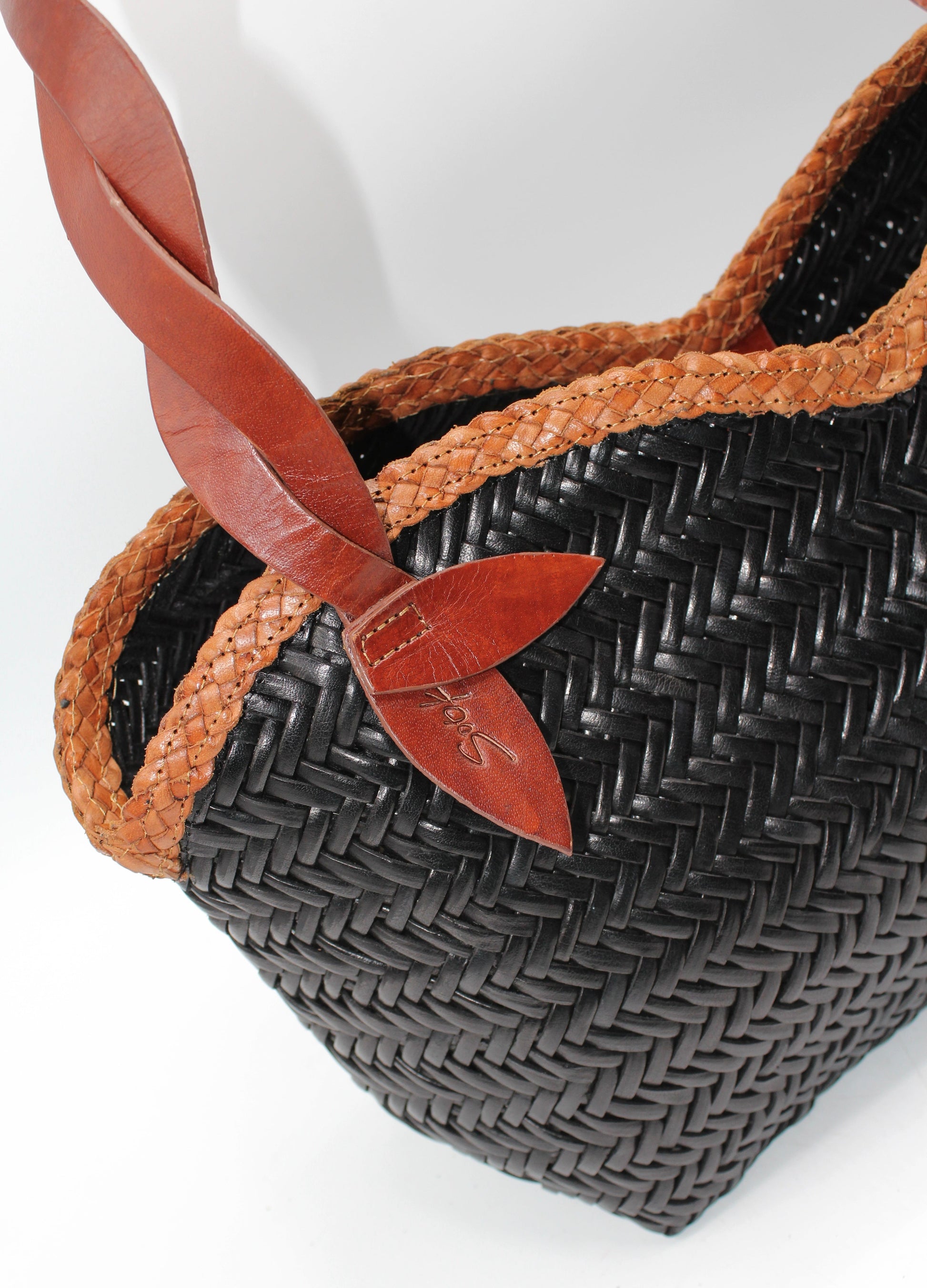 Léafa - Handwoven Leather Shoulder Bag | Brown & Black featuring braided brown edges and twisted leather handles on woven black body.
