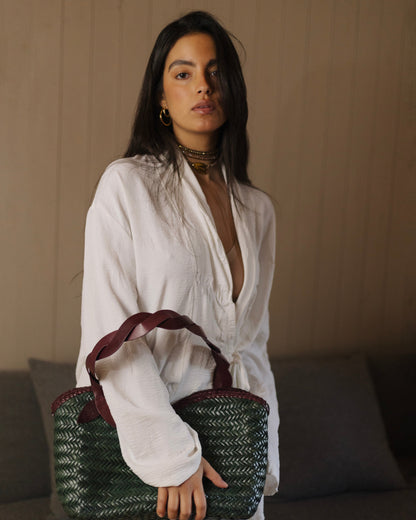 Léafa - Handwoven Leather Shoulder Bag | Burgundy & Green featuring braided burgundy leather handles and woven green leather body against neutral background.