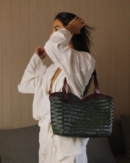 Léafa - Handwoven Leather Shoulder Bag | Burgundy & Green featuring woven green leather body with burgundy braided trim and burgundy leather handles.
