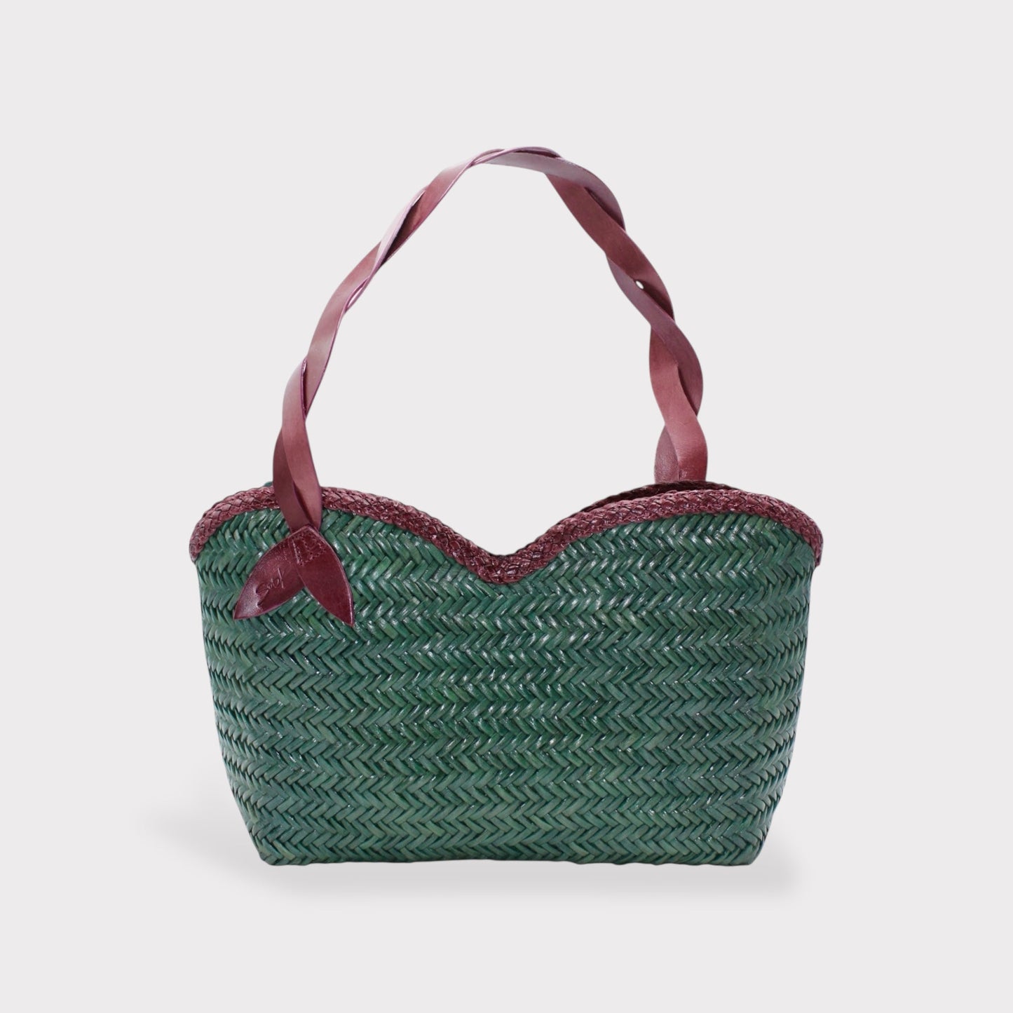 Léafa - Handwoven Leather Shoulder Bag | Burgundy & Green featuring woven leather body with braided edges and twisted burgundy leather handles.