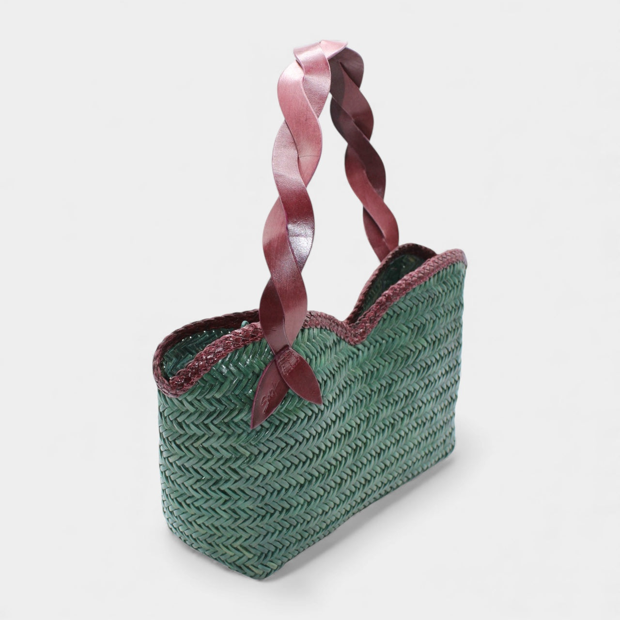 Léafa - Handwoven Leather Shoulder Bag | Burgundy & Green with braided burgundy leather handles and textured green woven leather body.