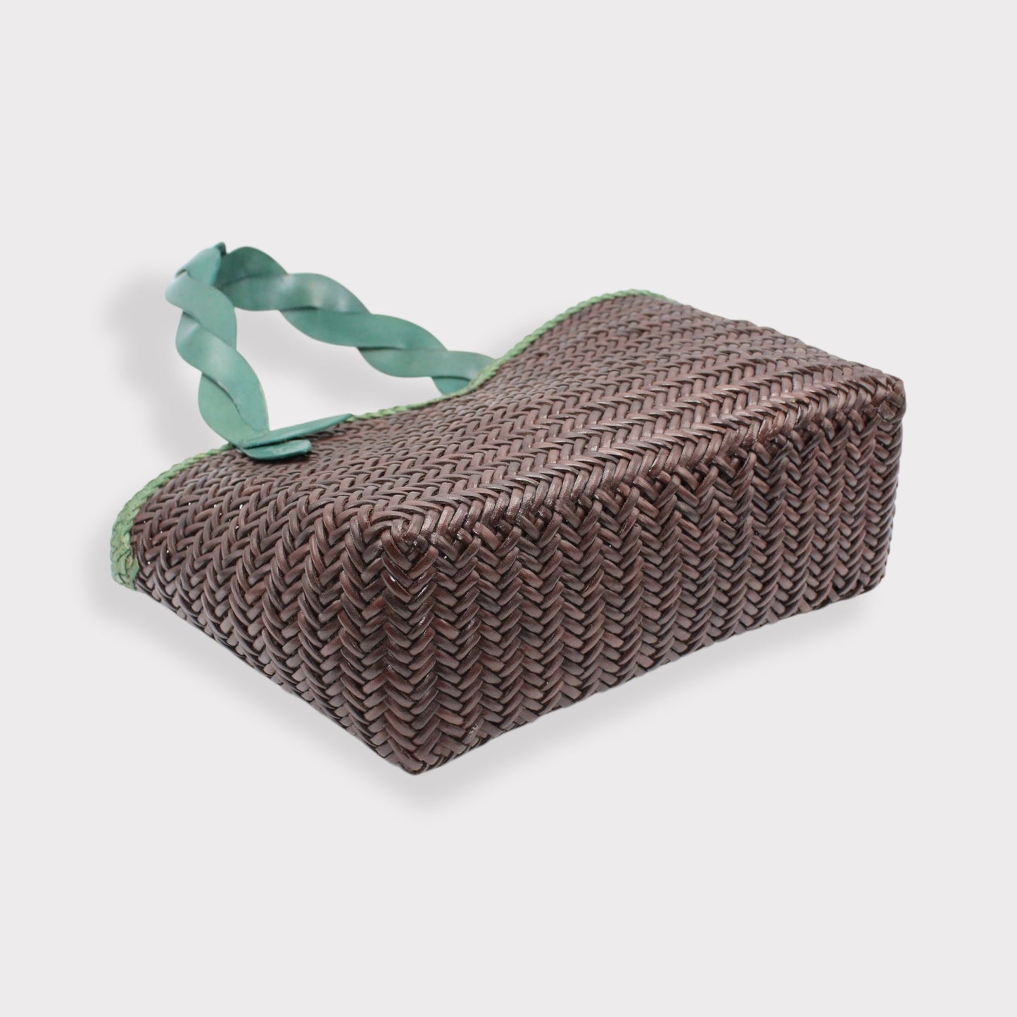 Léafa - Handwoven Leather Shoulder Bag | Green & Coffee showing woven leather base with twisted green leather handles on plain background.