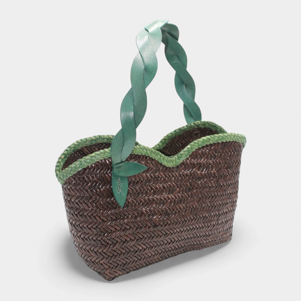 Léafa - Handwoven Leather Shoulder Bag | Green & Coffee featuring braided green leather handles and dark woven leather body with scalloped trim.