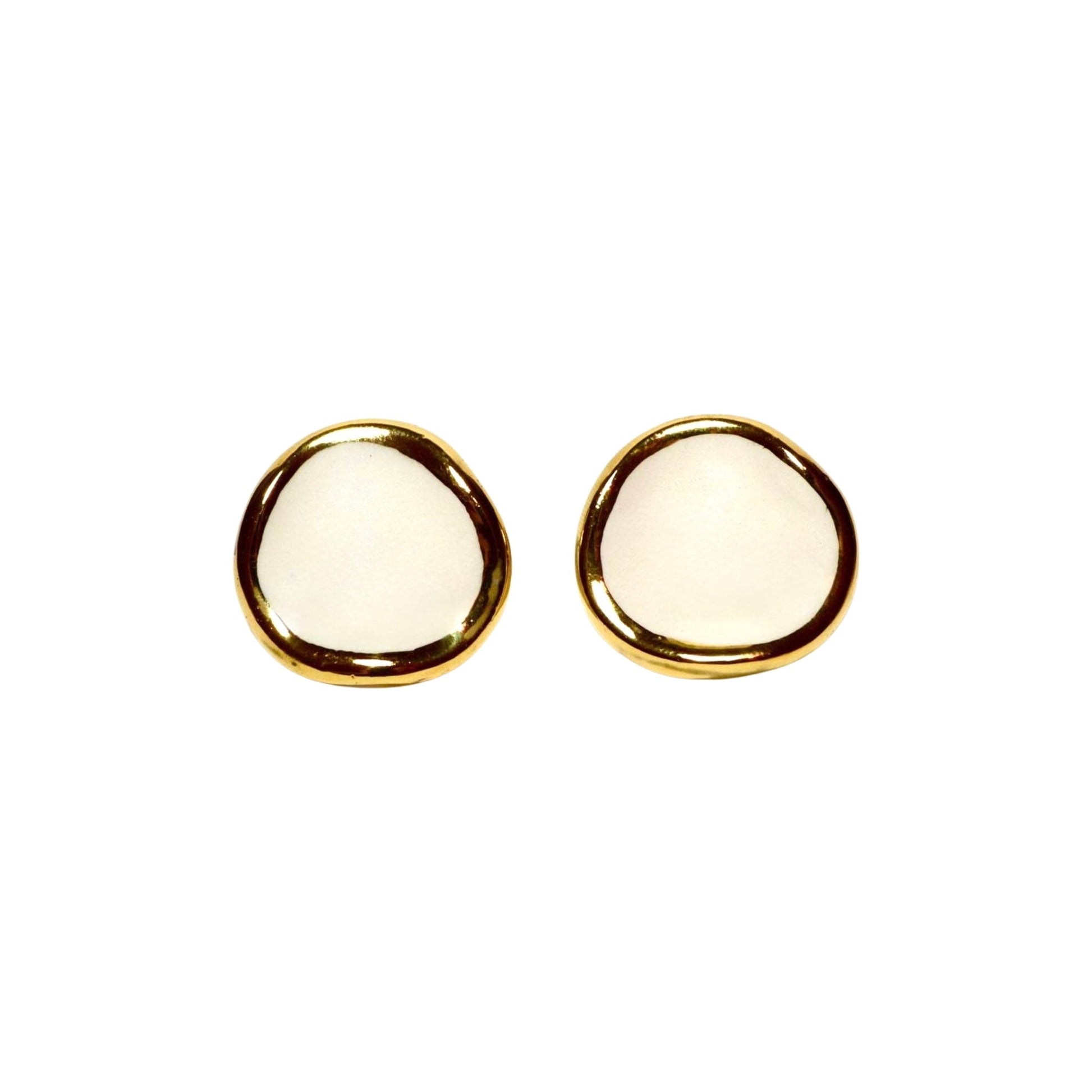 Two white ceramic stud earrings with gold rims arranged side by side