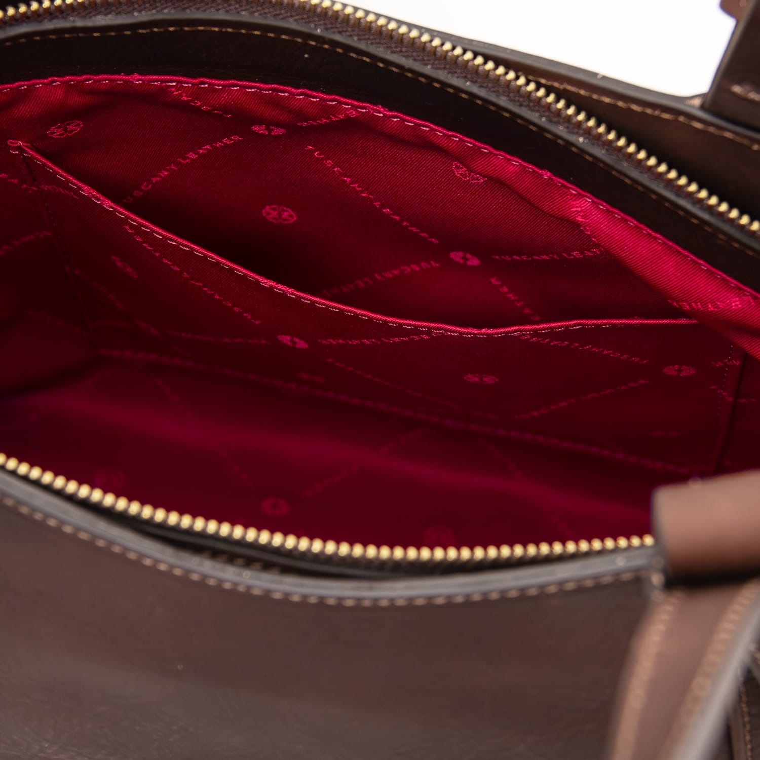 Close view of Libra tote interior showing red lining and zip pocket