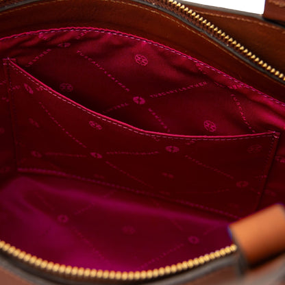 Interior view of Libra long handle leather tote with magenta lining featuring brand pattern and a pocket.