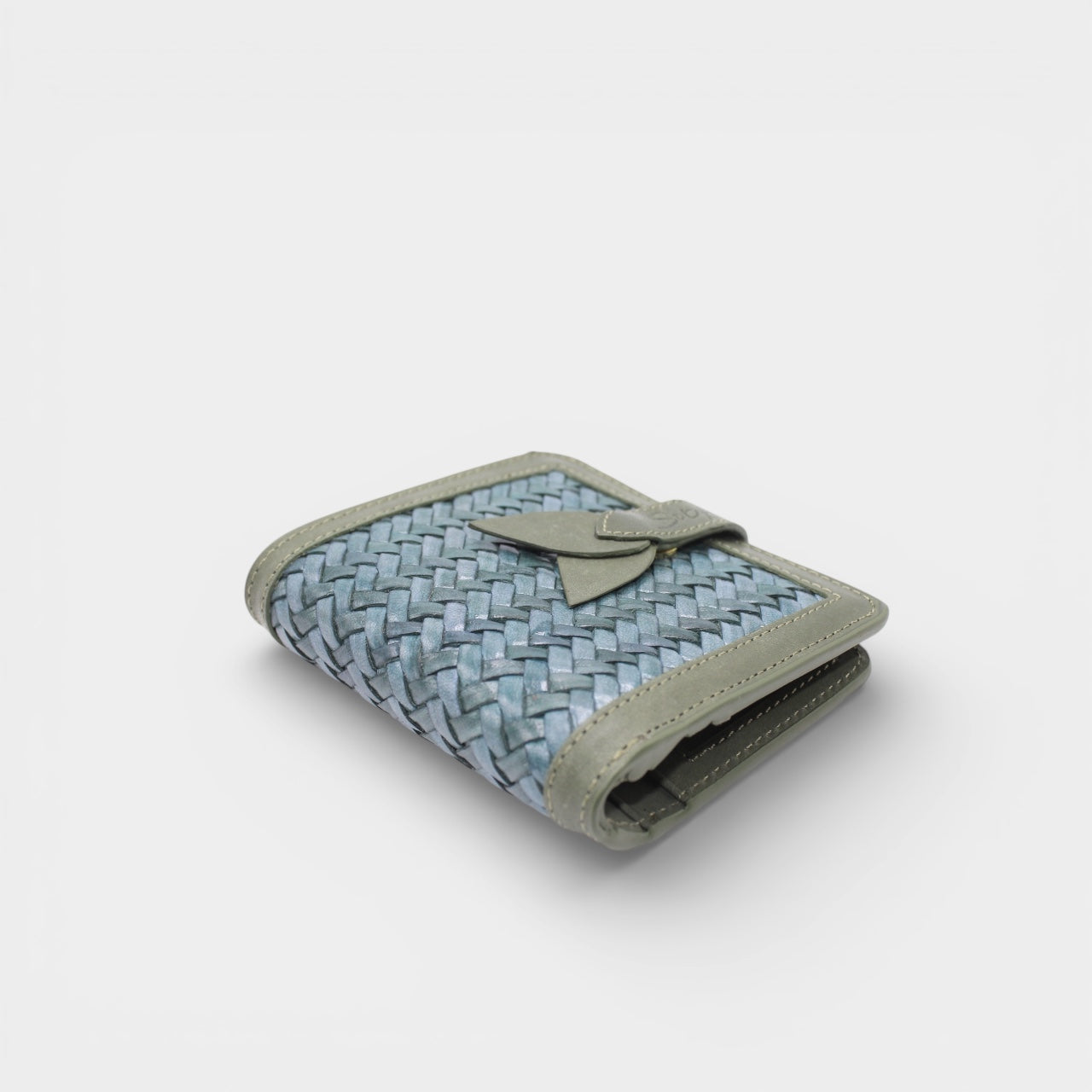 Lumi - Handwoven Leather Wallet | Avocado & Teal displaying woven teal leather with smooth avocado leather trim and a tab closure detail.