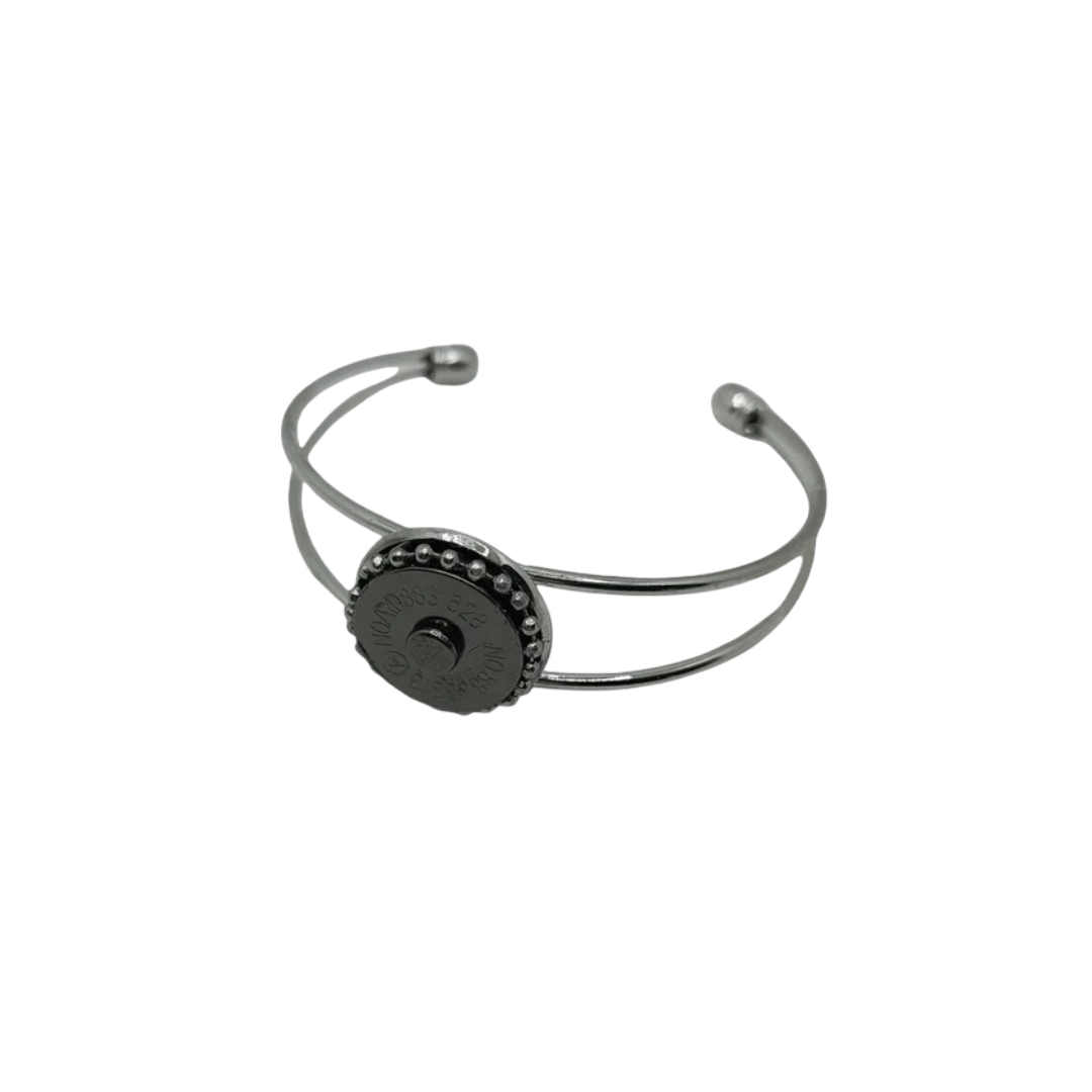 Silver bracelet with a black center stone on a white background