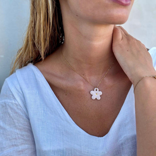 Margherita pink floral ceramic necklace with a delicate gold chain resting at the collarbone.