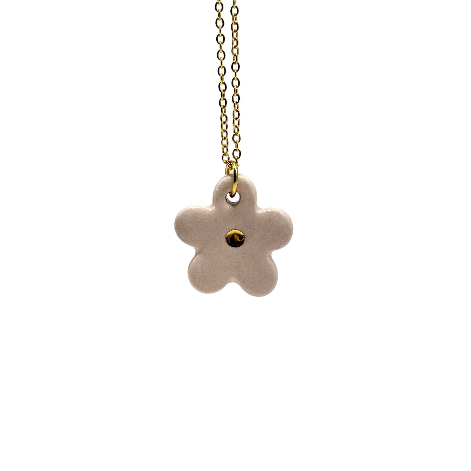 Handcrafted pink ceramic flower pendant with a gold chain against a white background.