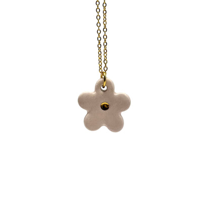 Handcrafted pink ceramic flower pendant with a gold chain against a white background.