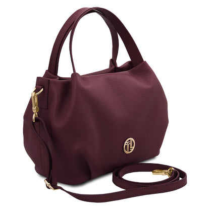 Nora - Soft leather handbag | TL142372 in burgundy pebbled leather with gold hardware and dual top handles on white background