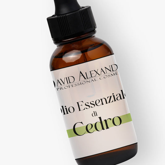 Close up of a cedarwood essential oil bottle tilted to display the Cedro label