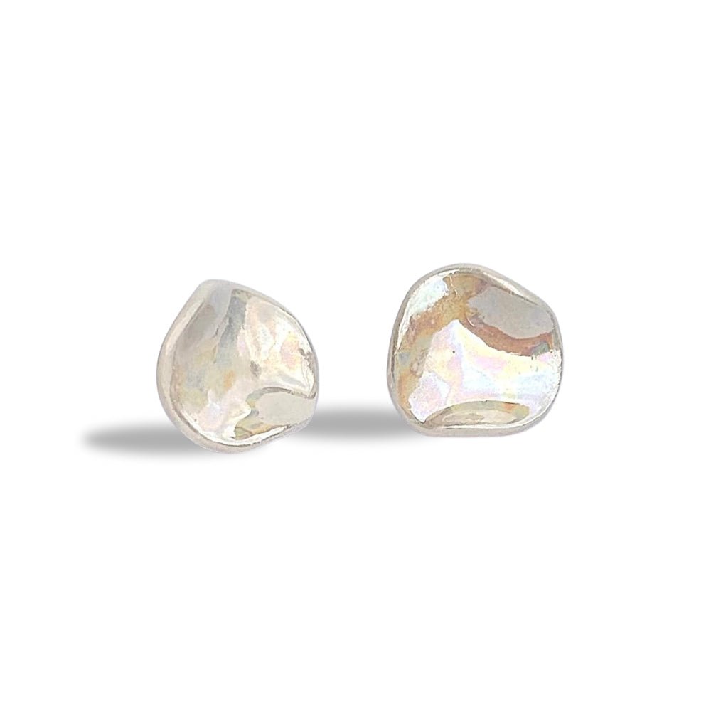 Irregular pearl white ceramic stud earrings on a white background