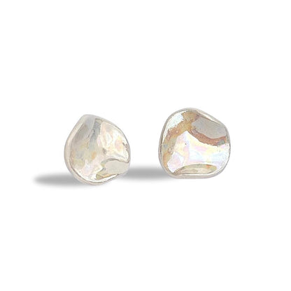 Irregular pearl white ceramic stud earrings on a white background