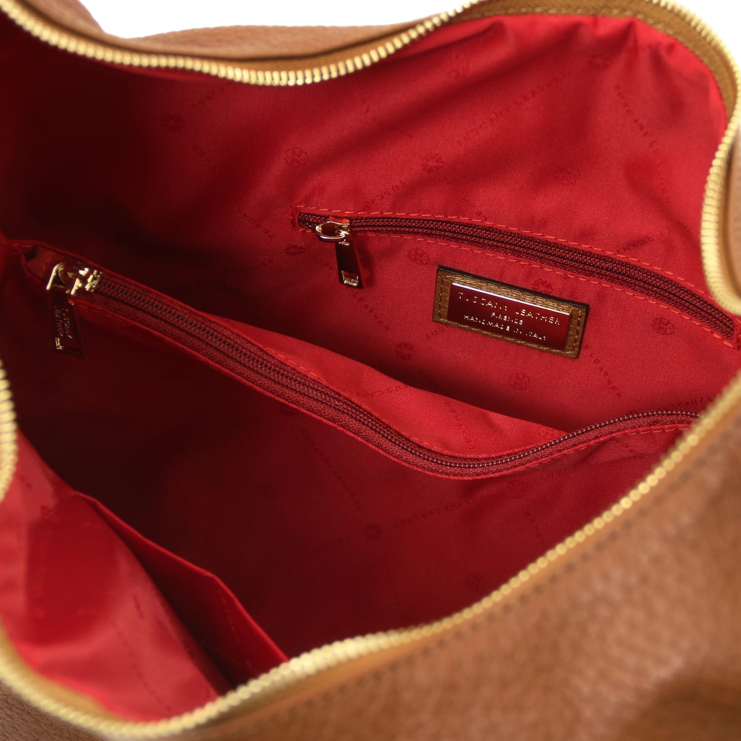 Interior view with red lining and a zippered pocket inside the bag.