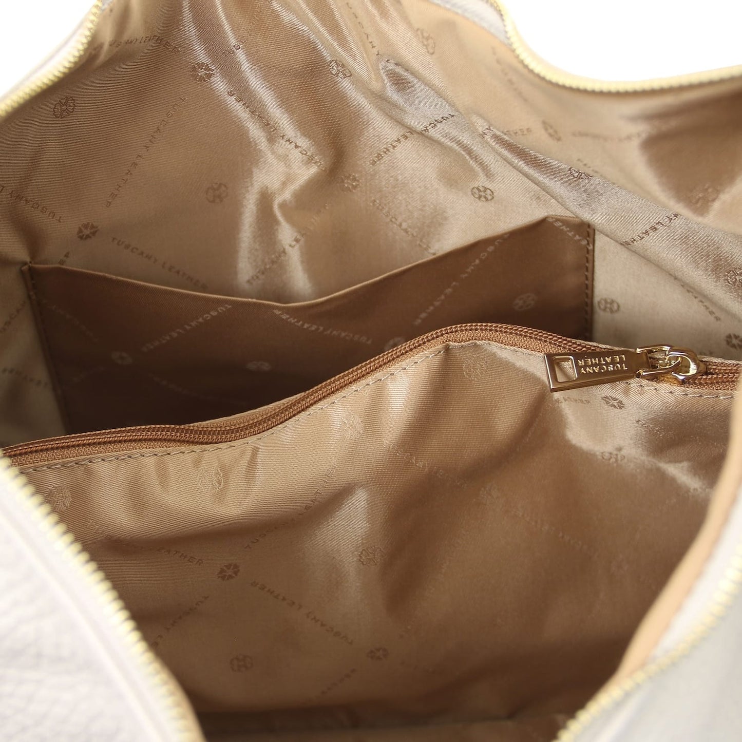 Tan interior of Plenia Italian leather shopping bag with a zipped pocket and logo patterned lining