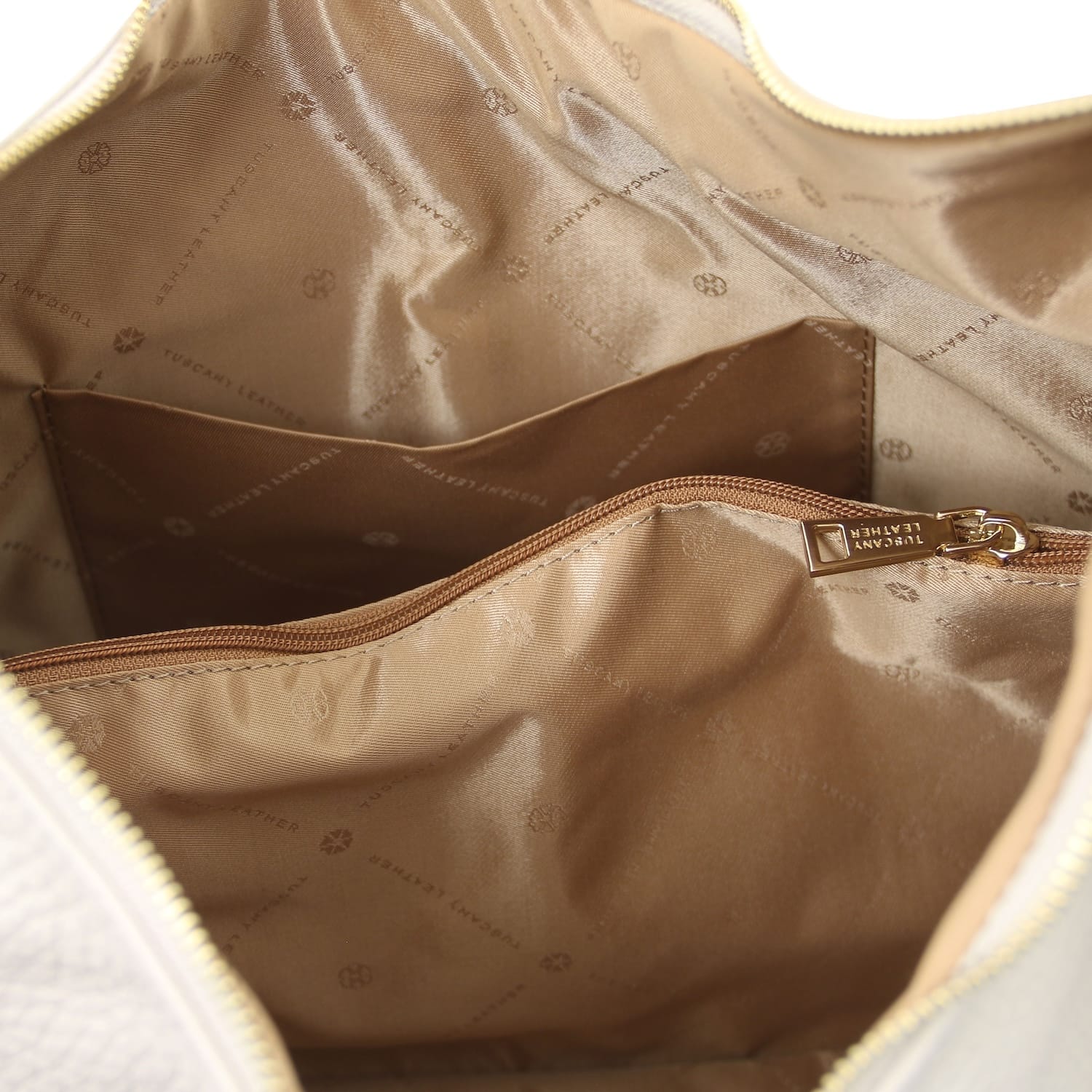 Tan interior of Plenia Italian leather shopping bag with a zipped pocket and logo patterned lining