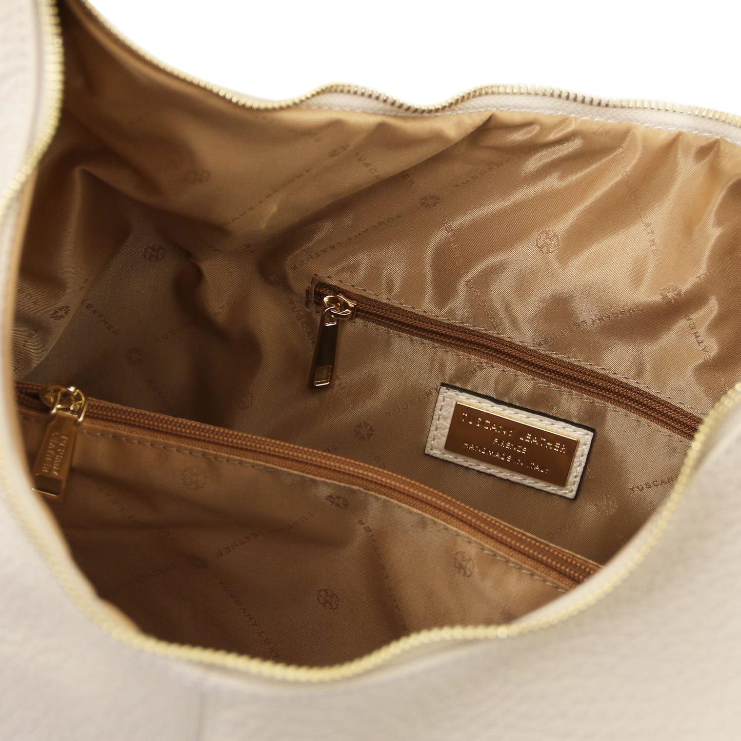 Inside view of the bag with brown lining zip pocket and brand plaque