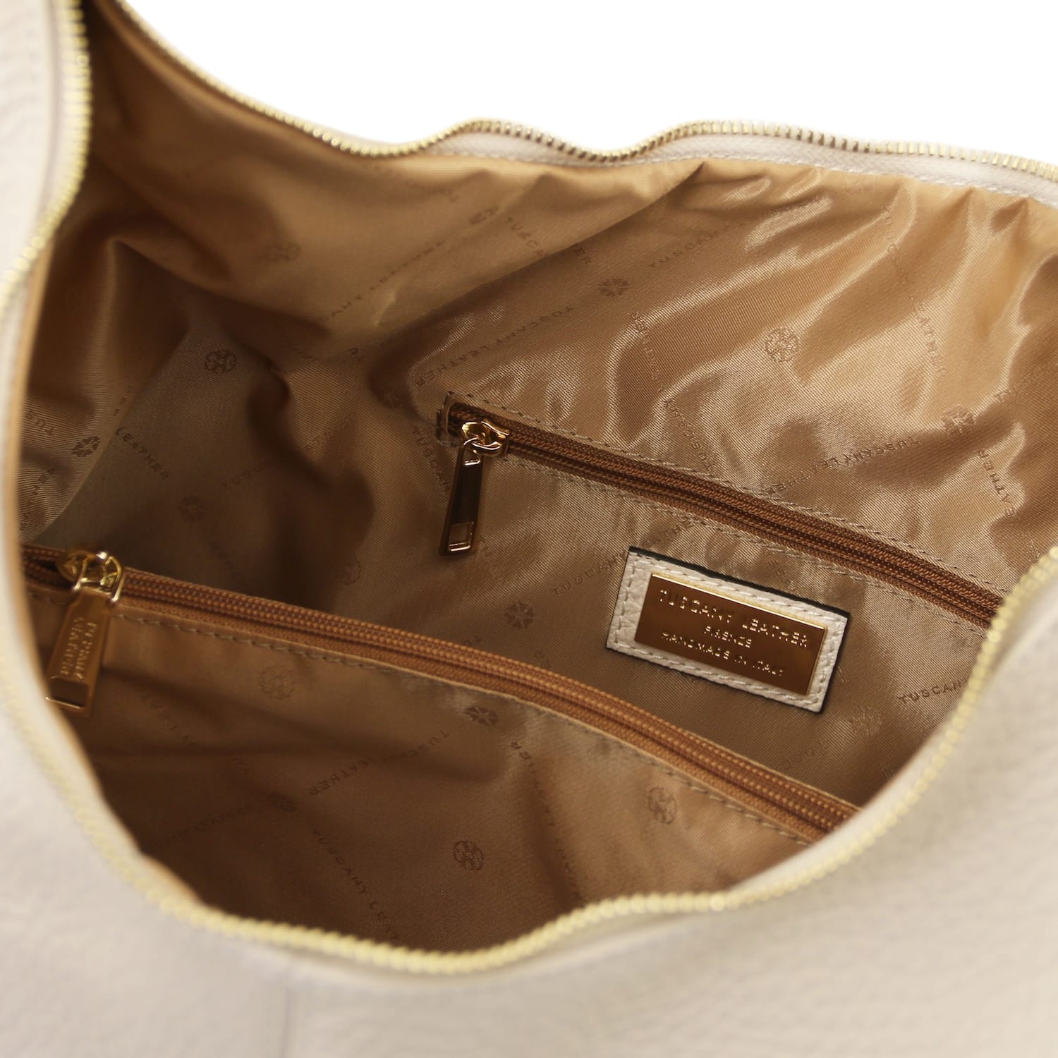 Inside view of the bag with brown lining zip pocket and brand plaque