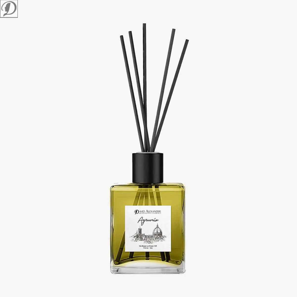 Reed diffuser in square glass bottle with yellow fragrance liquid and a black cap