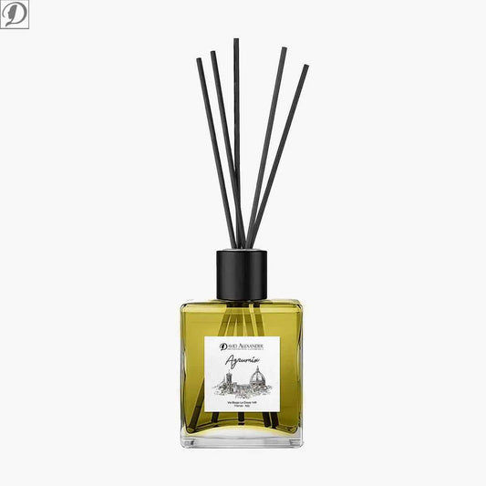 Reed diffuser in square glass bottle with yellow fragrance liquid and a black cap