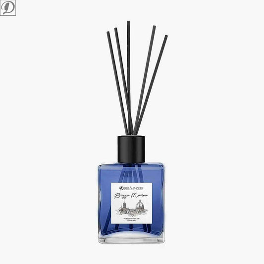 Blue glass reed diffuser bottle with black cap and several black reeds Brezza Marina fragrance