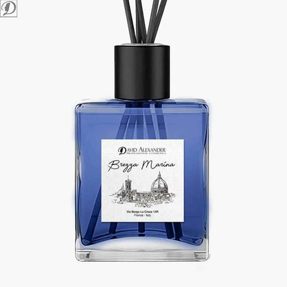 Blue glass room fragrance bottle with black cap and diffuser reeds labeled Brezza Marina
