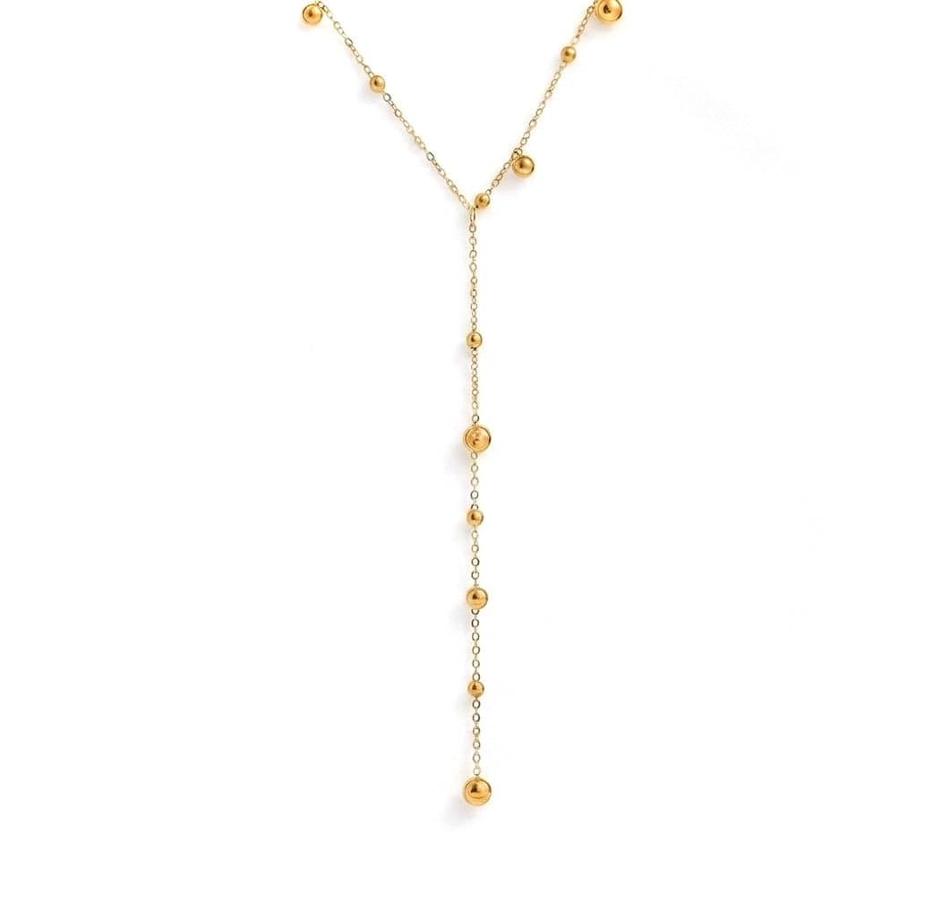 Gold necklace with small beads on a white background