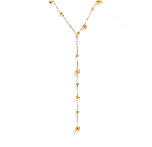 Gold necklace with small beads on a white background