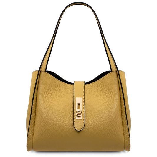 Front view of mustard leather handbag with curved top, top strap and gold lock.