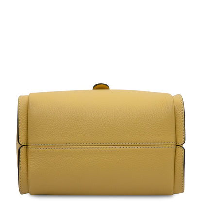 Base of mustard yellow soft leather handbag with visible stitching.