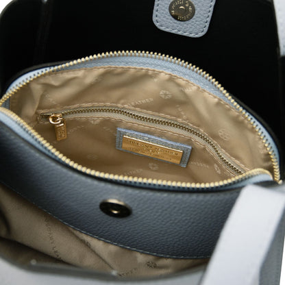 Inside view of the Soave handbag with beige lining, zip pocket and a gold label plaque.