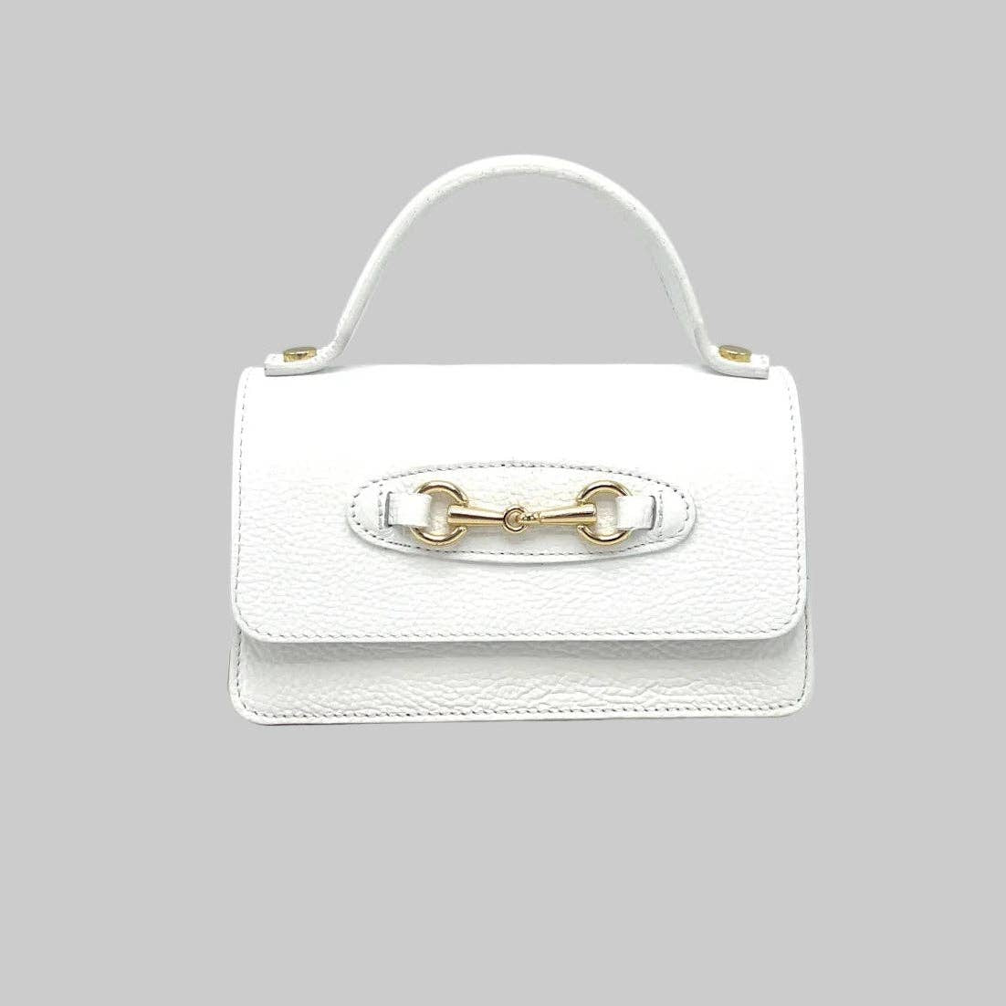 White handbag with gold hardware on a light gray background