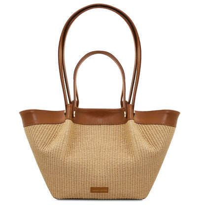 Soleil raffia shopping bag with brown leather trim and handles on white background.