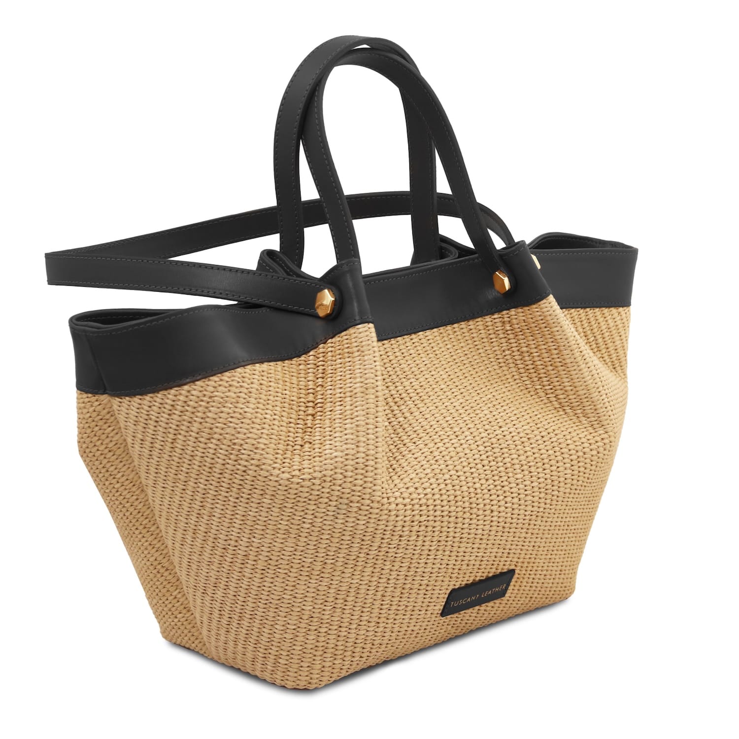 Three-quarter view of raffia shopping bag with black leather trim and long shoulder strap.
