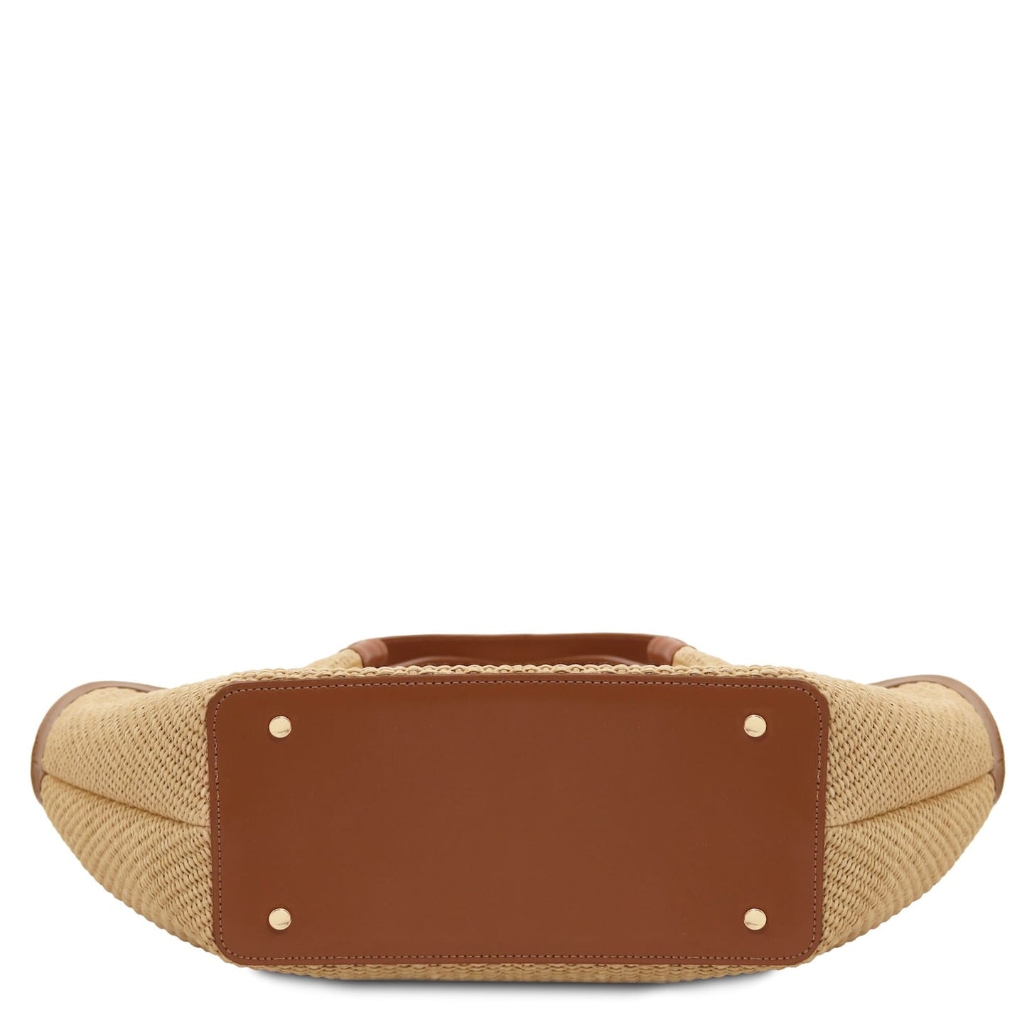 Bottom view of raffia shopping bag showing brown leather base panel and metal studs