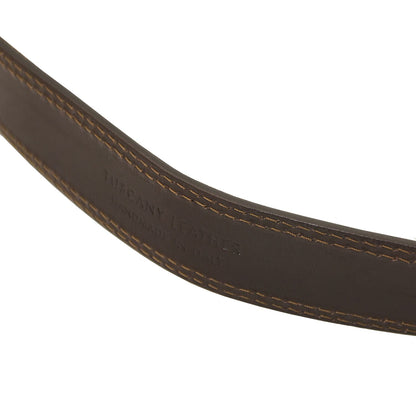 Close-up of a brown leather belt with visible stitching on a white background