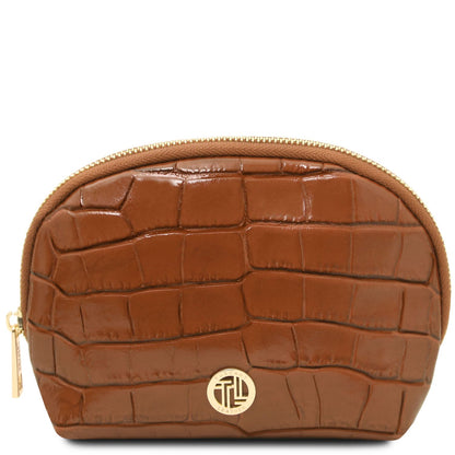 A red crocodile-embossed zippered cosmetic pouch with gold-tone hardware and a circular metal logo emblem on the front, shown against a plain white background.