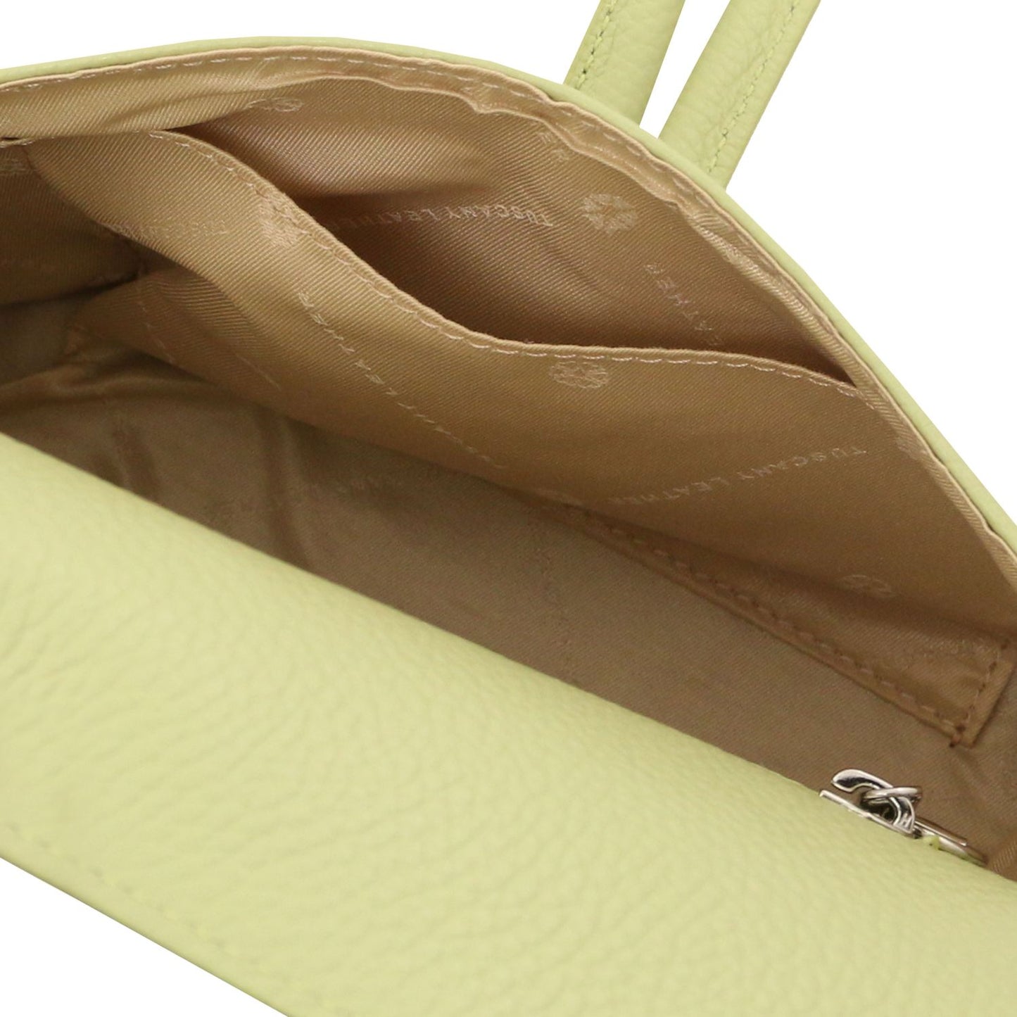 Interior view of lime green foldover leather clutch with tan lining and inner pocket