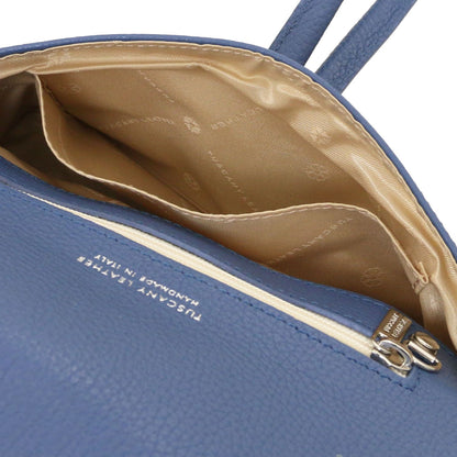 Open blue leather clutch with beige patterned lining and internal pocket.