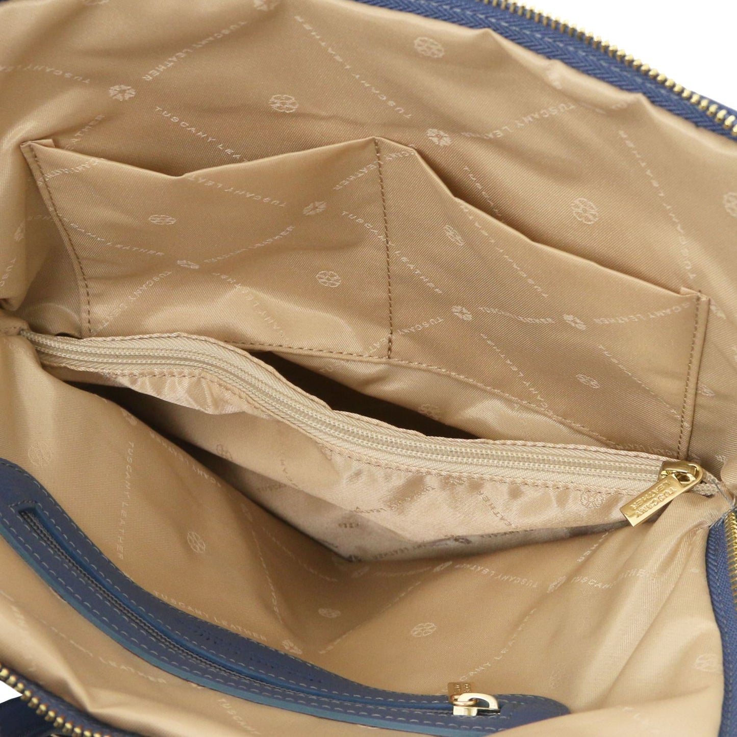 Tan interior of TL Bag with zip pocket and organized slots.