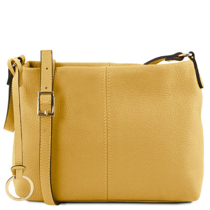 Mustard yellow soft leather shoulder bag with adjustable strap and gold buckle and circular ring charm.