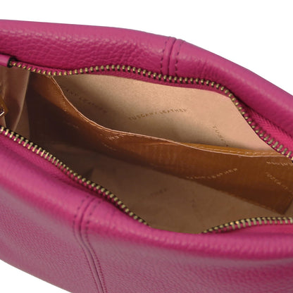 Close-up of a pink soft leather shoulder bag showing the interior with multiple compartments and a zipper closure.