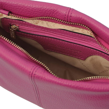 Open view of a pink soft leather shoulder bag showing smooth interior lining and zippered pocket with gold-tone zipper pull.